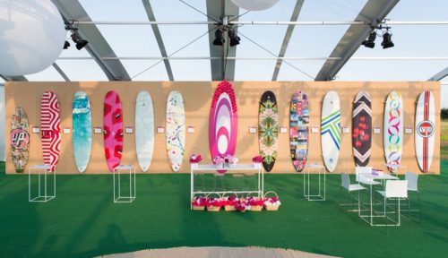 A display of surfboards in a tent.