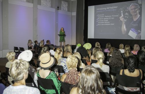 A woman is giving a presentation to a group of people.