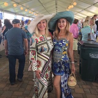 Two women in hats standing next to each other.