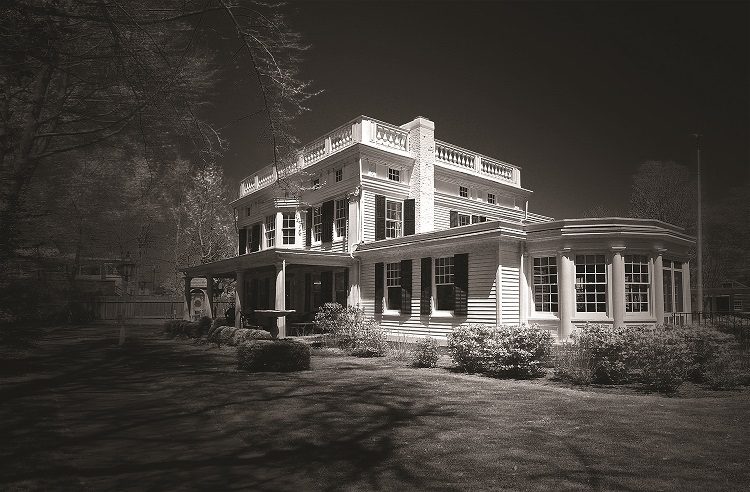 A black and white photo of an old house.
