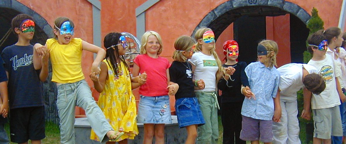 A group of children standing in front of a building.