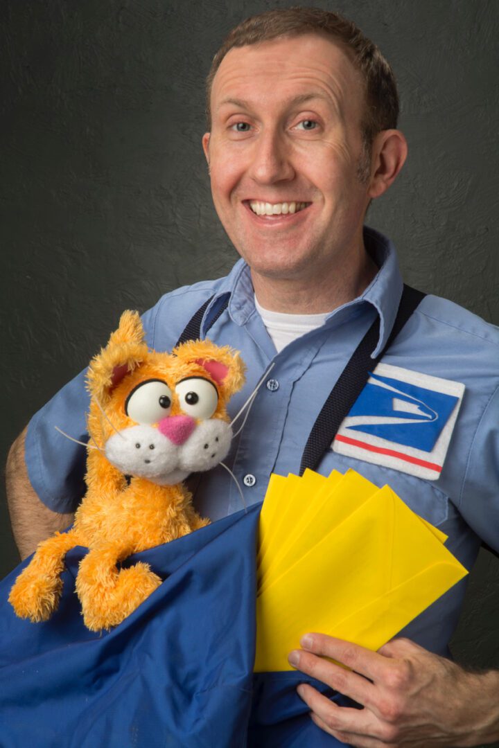 A man holding a stuffed cat and mail.