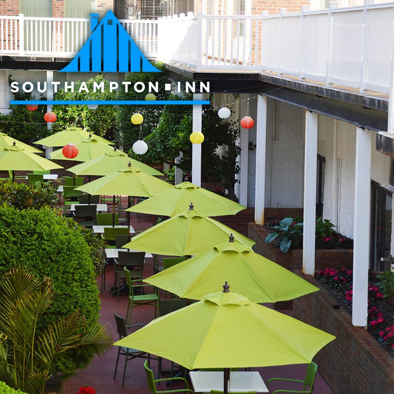 Green umbrellas on the patio of a hotel.
