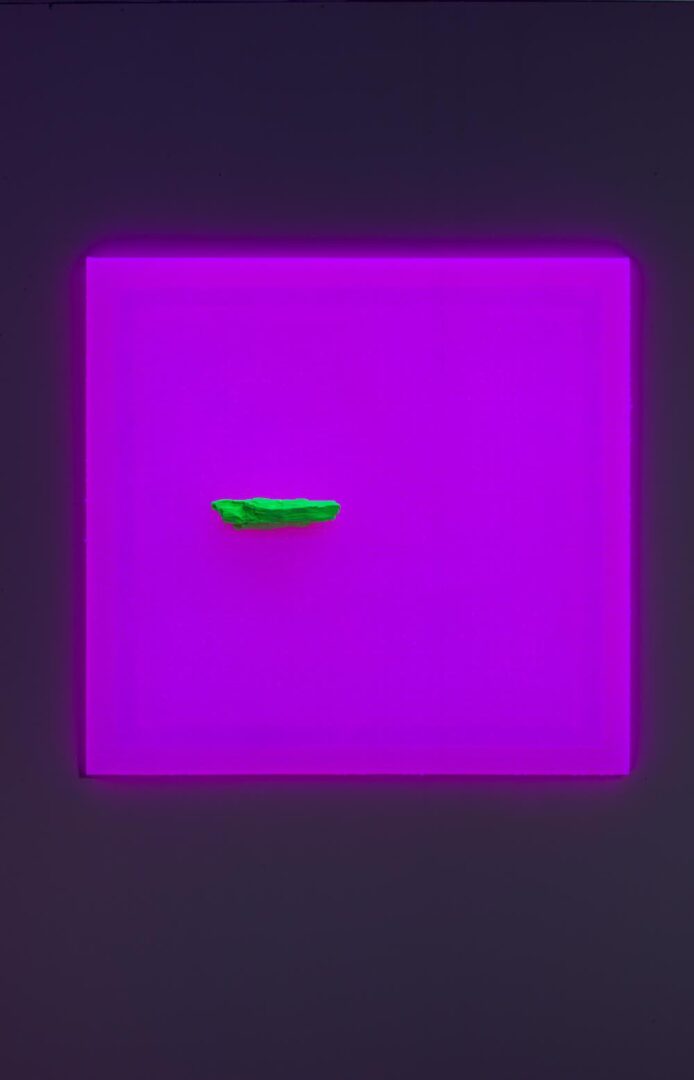 A piece of art with a purple light on it.