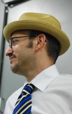A man wearing a hat and tie.