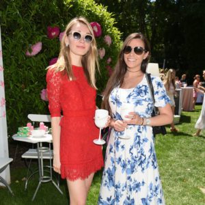 Two women standing next to each other at an outdoor event.