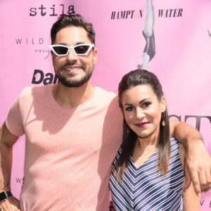 A man and woman posing for a photo at an event.