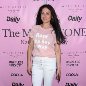 A woman wearing white jeans and a pink t shirt at the wild spirit event.