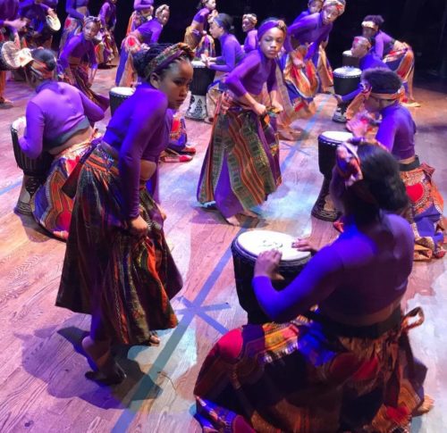 A group of african dancers on stage.