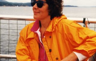 A woman wearing a yellow jacket.