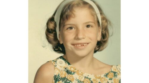 Close up shot of a small girl smiling at the camera