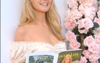 Here's an alt tag for the image: Smiling woman holding Social Life magazine.