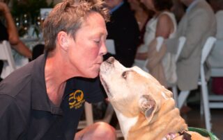 Woman kissing her adopted dog.