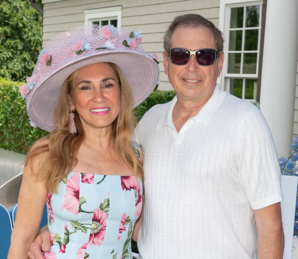 Young man with a slight smile against a gray background.