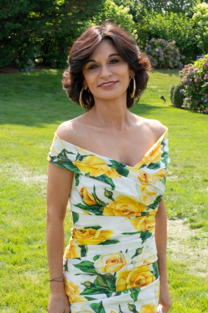 Young man with a slight smile against a gray background.