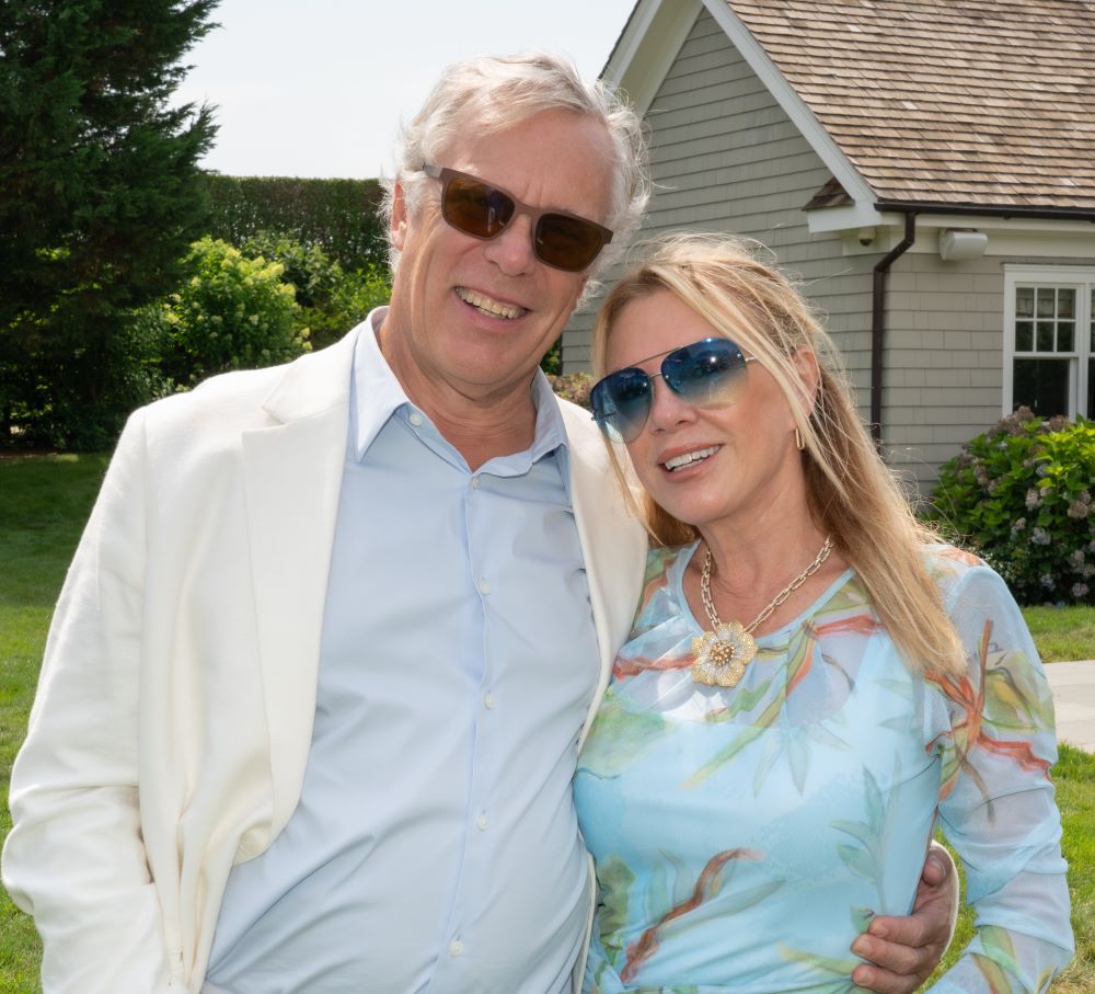 Young man with a slight smile against a gray background.