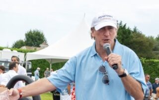 Man speaking into microphone at event.