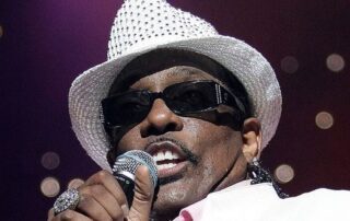 Singer Bobby Brown singing into microphone.