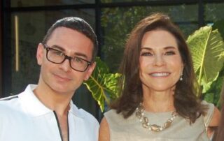 Two people, man wearing glasses, woman smiling.