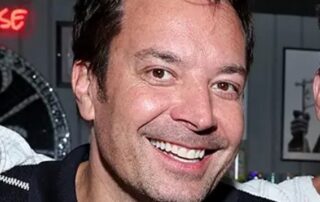 Smiling Jimmy Fallon in striped shirt.