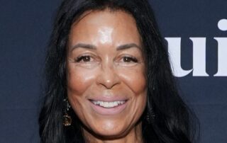 Woman with long black hair smiling.