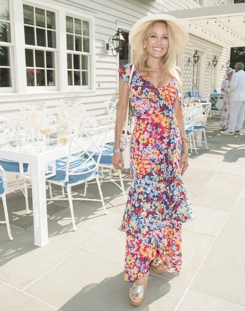 Young man with a slight smile against a gray background.