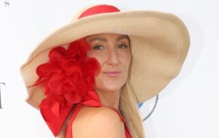 Woman in red and beige hat.
