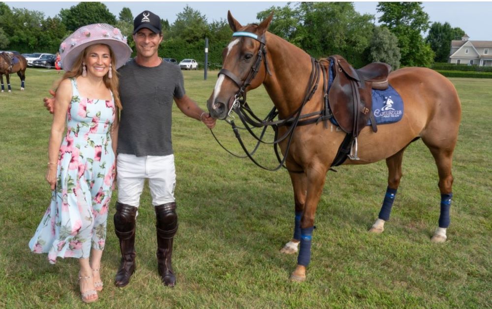 Young man with a slight smile against a gray background.