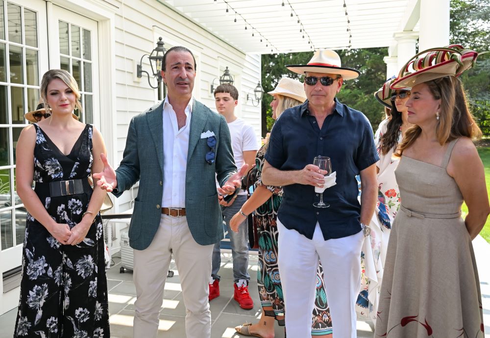 Young man with a slight smile against a gray background.