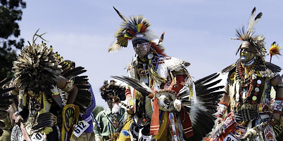 Native American dancers in colorful regalia.