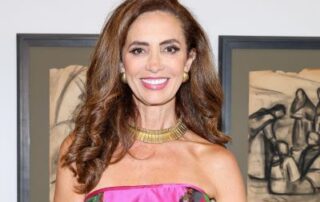 Woman in pink dress at art gallery.