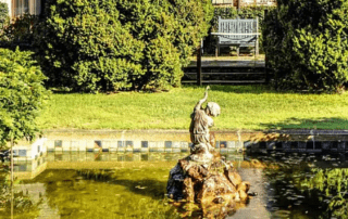 Garden fountain with cherubic statue.