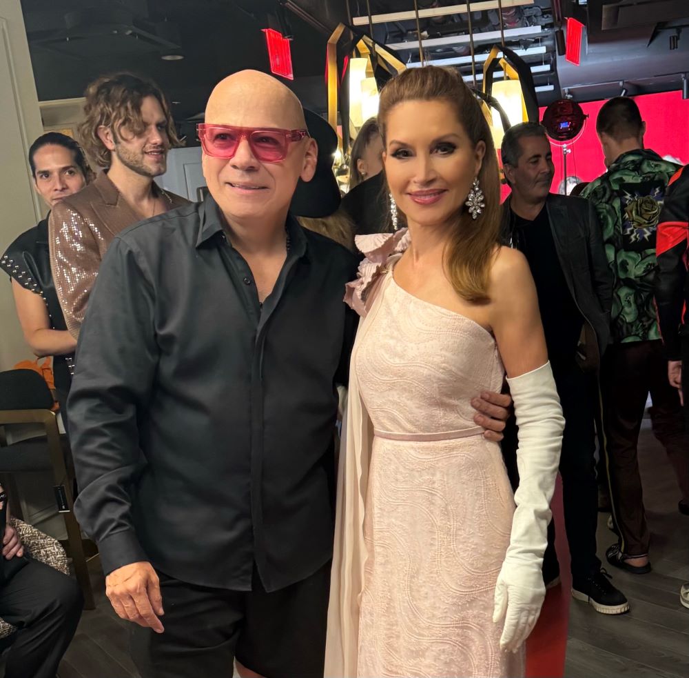 Young man with a slight smile against a gray background.