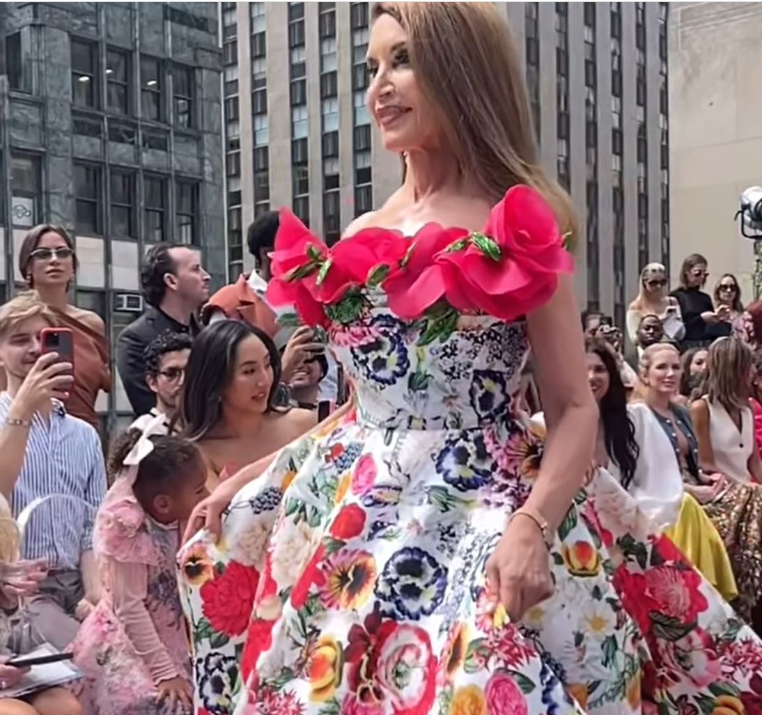 Young man with a slight smile against a gray background.