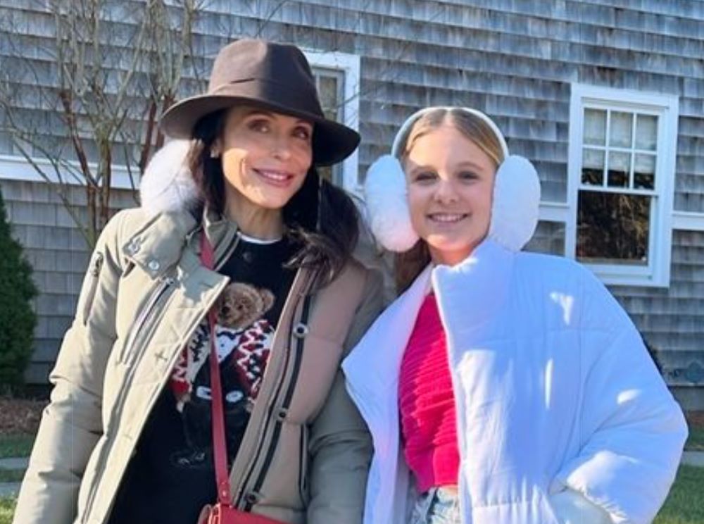 Young man with a slight smile against a gray background.