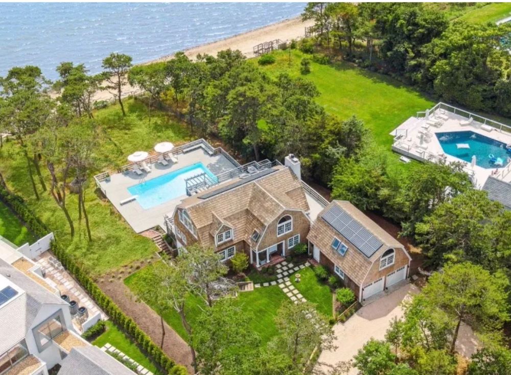 Young man with a slight smile against a gray background.