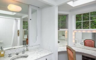 Bright white bathroom with vanity and mirror.