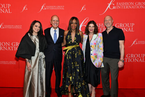 Five elegantly dressed individuals posing at a Fashion Group International event.