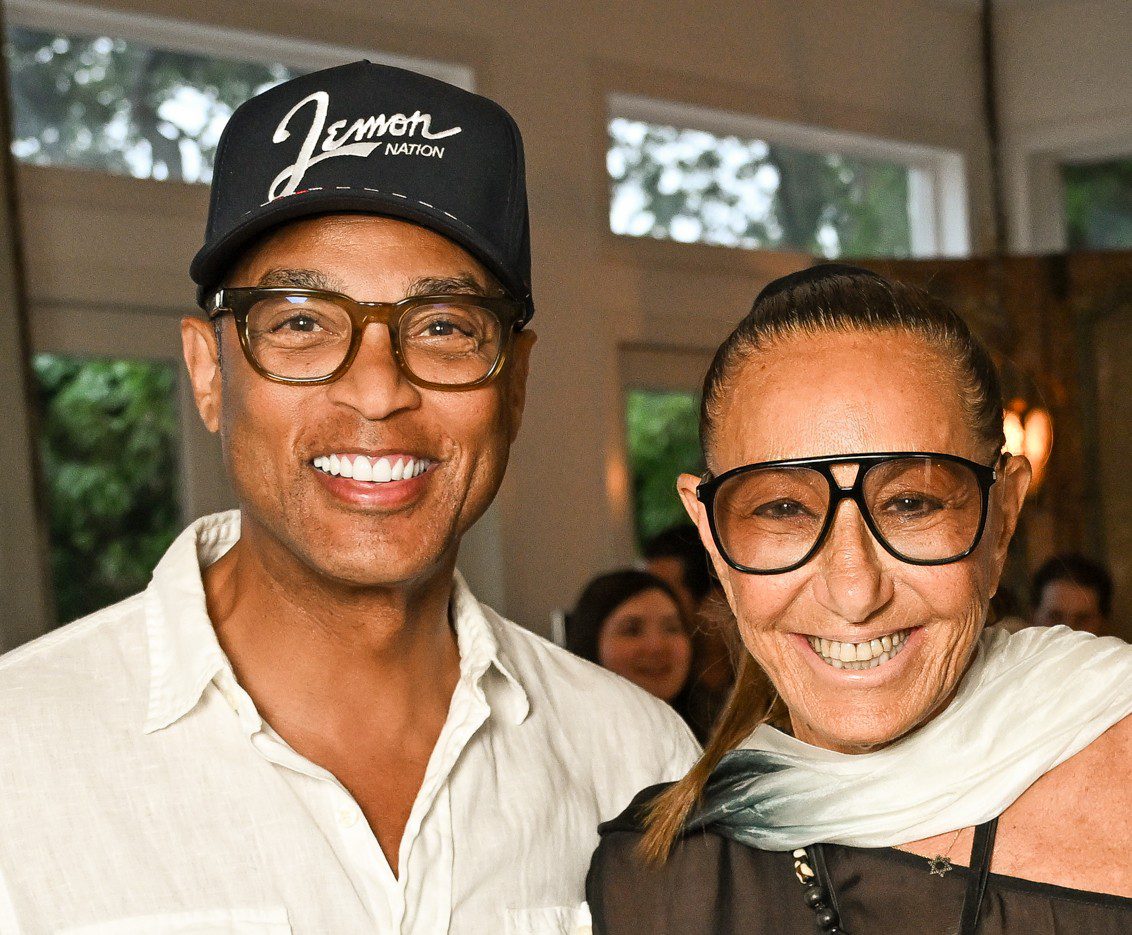 Two smiling individuals wearing glasses and posing indoors.