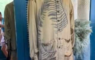 Beige button-up shirt with unique tiger stripe patterns and matching pants.