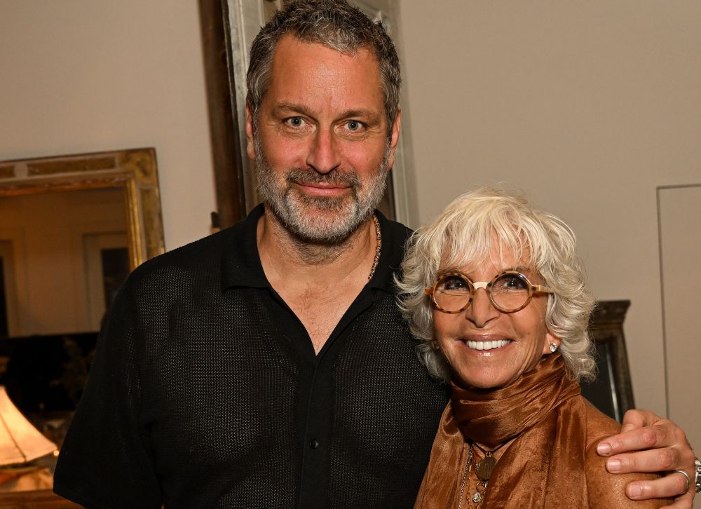 A man and woman smiling together indoors.