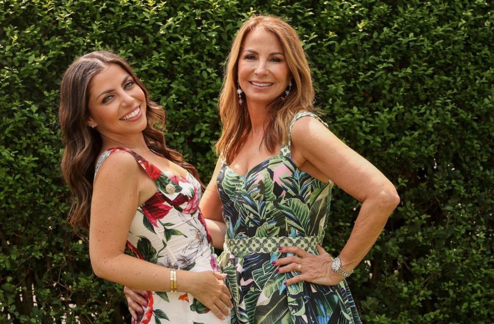 Young man with a slight smile against a gray background.