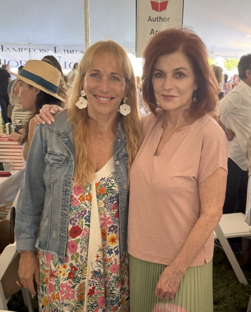 Close-up portrait of a confident woman with red hair and red lipstick.
