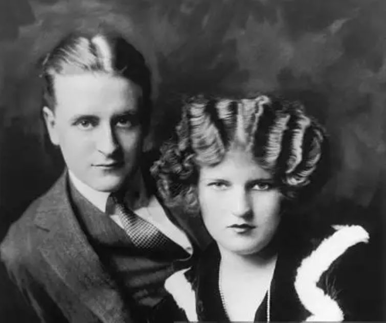 Young man with a slight smile against a gray background.