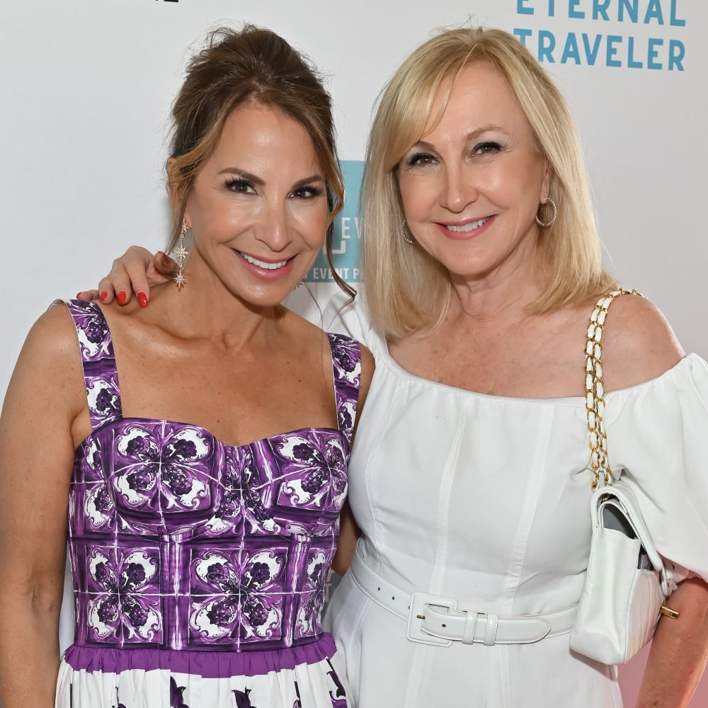 Young man with a slight smile against a gray background.