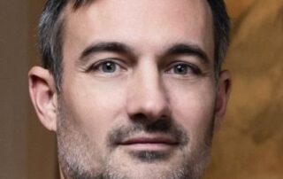 Portrait of a middle-aged man with short hair and light stubble.