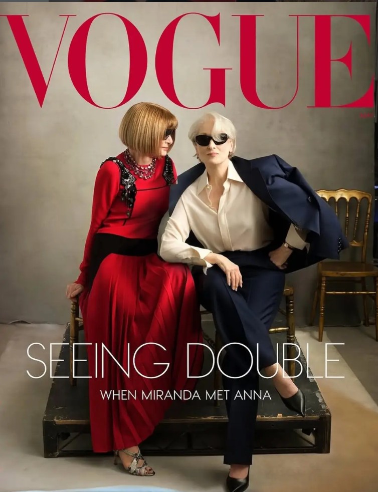 Two stylish women pose together for Vogue's cover, showcasing contrasting fashion styles.